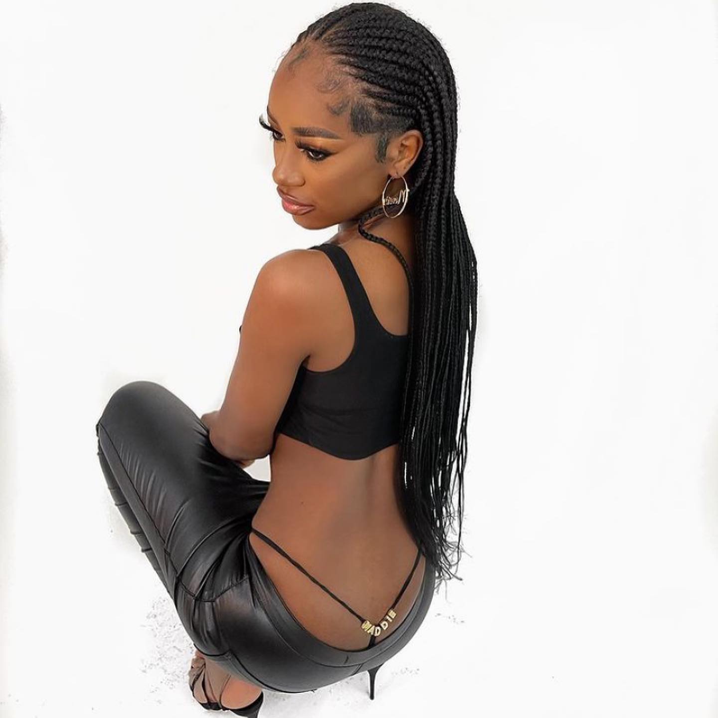 Black handmade personalized letter thong modeled on a white studio background