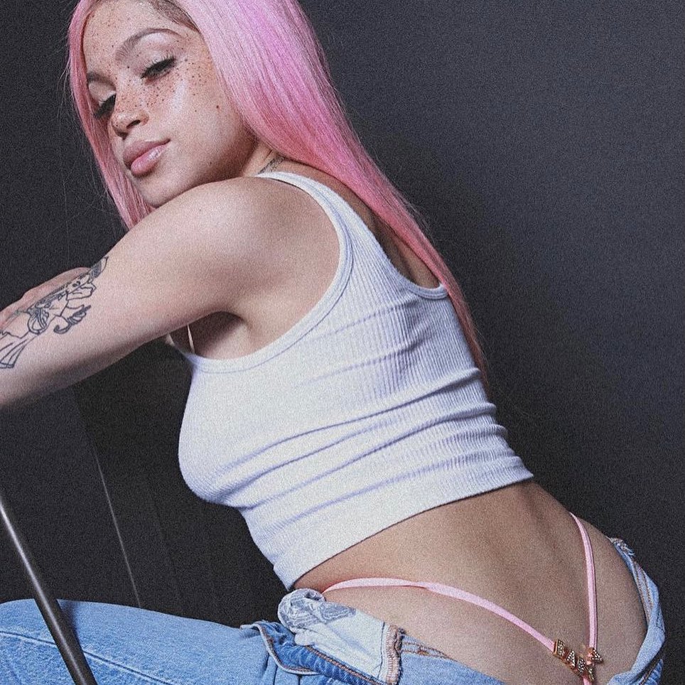 Woman modeling a pink handmade personalized thong with jeans