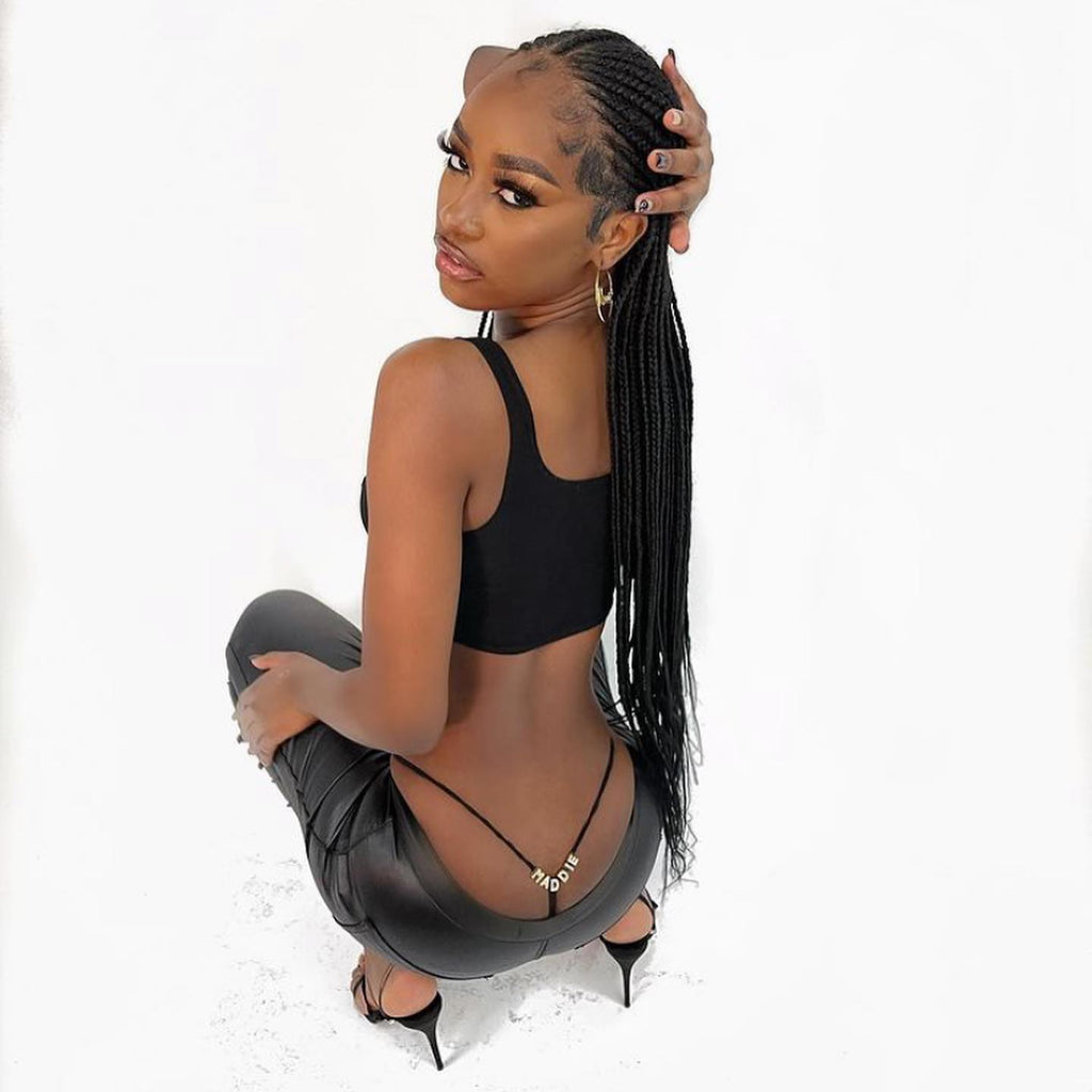 Black custom letter thong modeled on a white studio background